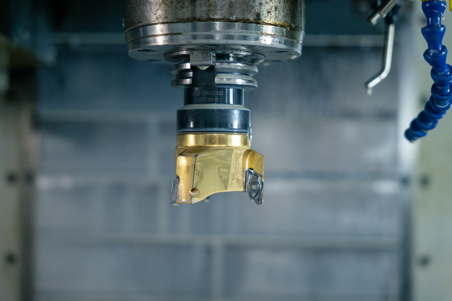 Indexable face mill cutter with carbide inserts mounted in a CNC machine spindle