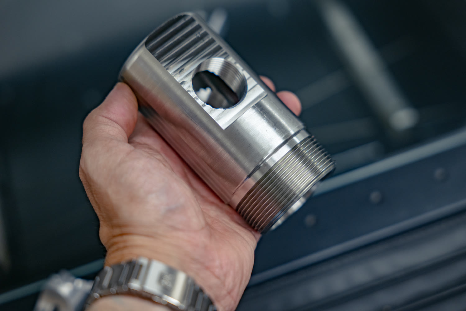 CNC machined stainless steel valve body with external threads and a milled port
