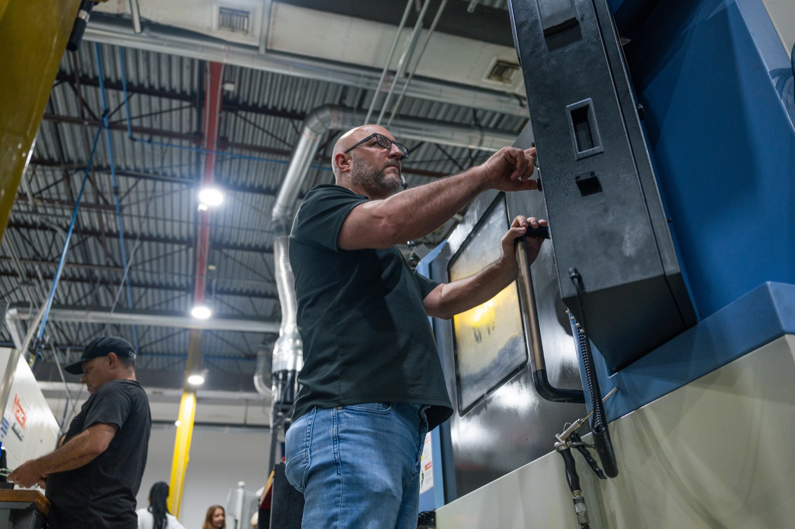 Machinist loading a part into a CNC machining center