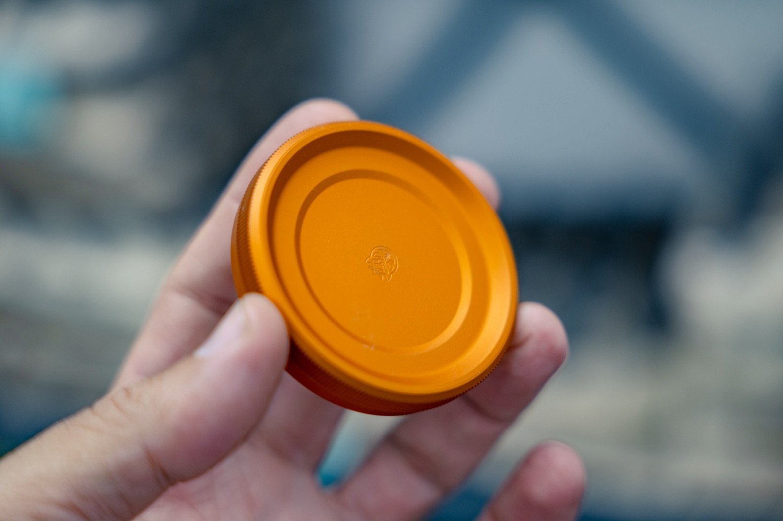 Orange anodized aluminum cap machined and finished in house