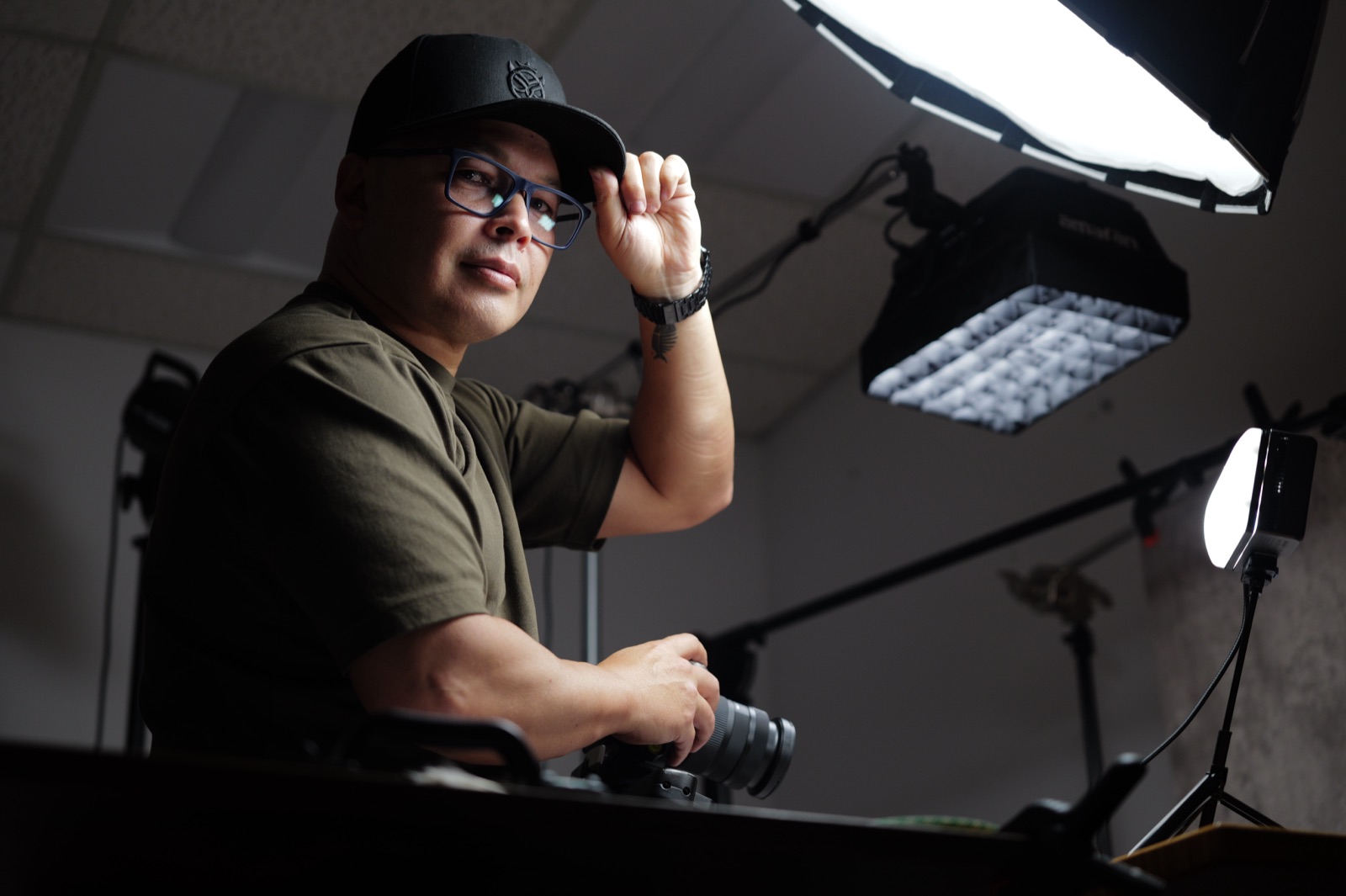 In-house photographer lighting and photographing machined parts