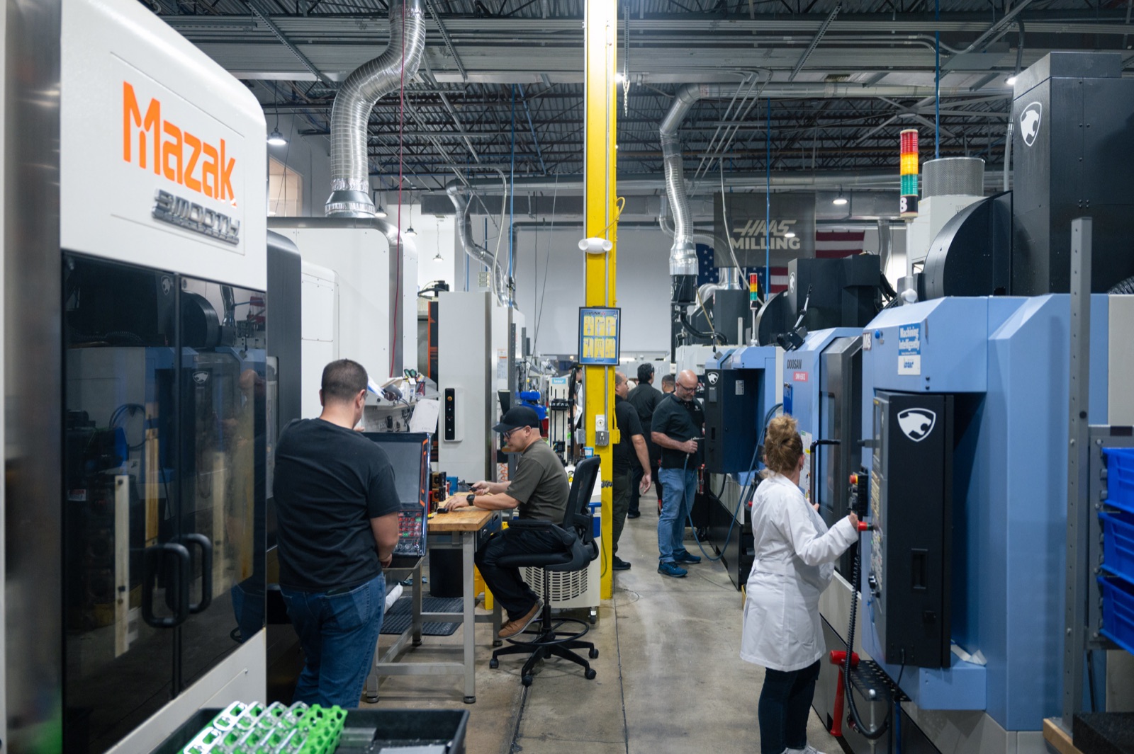 The Manufacture US team working among the CNC machines on the shop floor