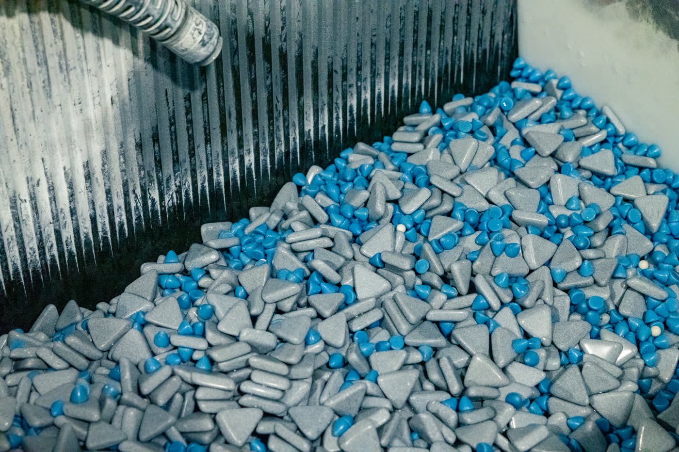 Ceramic media in a vibratory finishing bowl used to deburr CNC machined parts